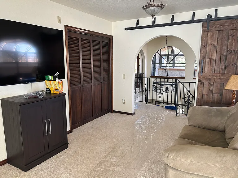 Master Suite sitting area with additional storage space. The opening can be closed by sliding the barn door.