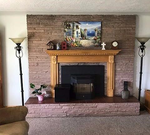 Raised hearth and beautiful mantel offer display space and additional seating...