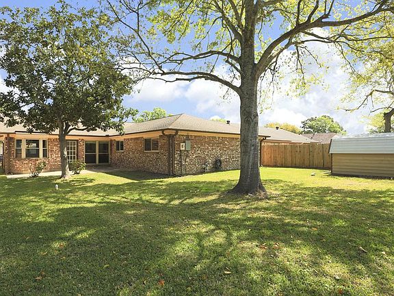 BACKYARD - a large fenced backyard with nice shade trees. The home is located only a block from the elementary school.
