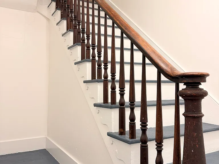Private front door entrance with elegant staircase.