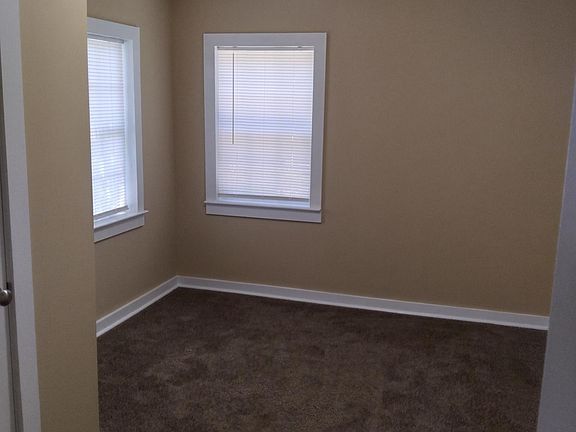 Front bedroom, carpeted, opens to hallway