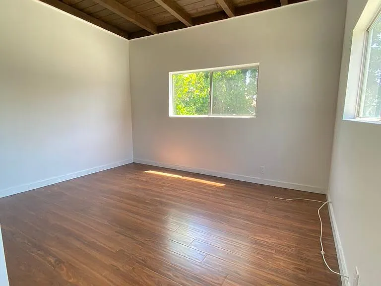 Master bedroom with brand new Pergo laminate flooring.