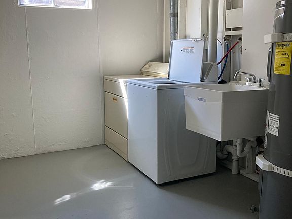 Large laundry room with utility sink. Brand new water heater.