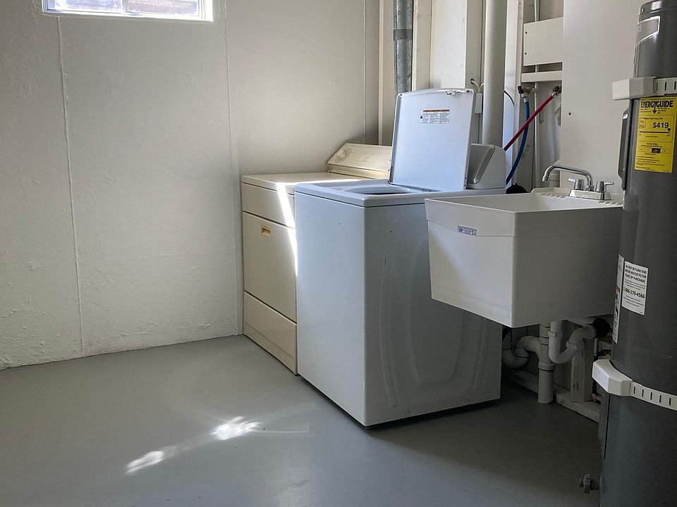 Large laundry room with utility sink. Brand new water heater.