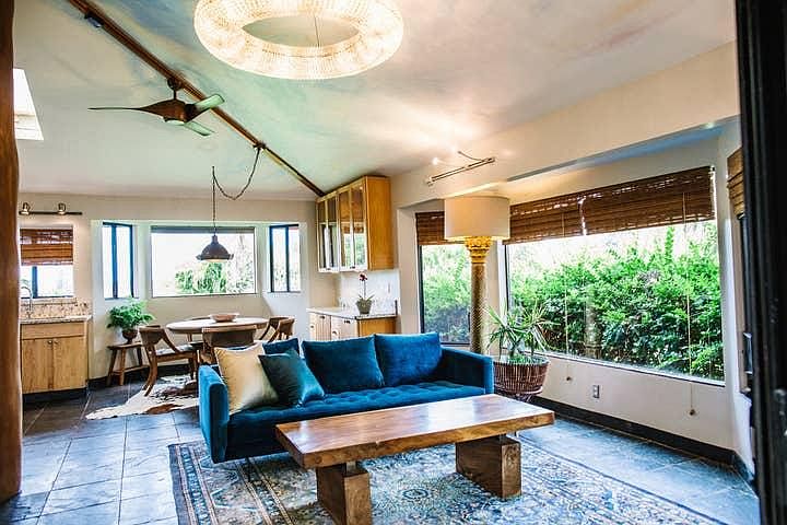 view ow living room and dining room with ceiling fan