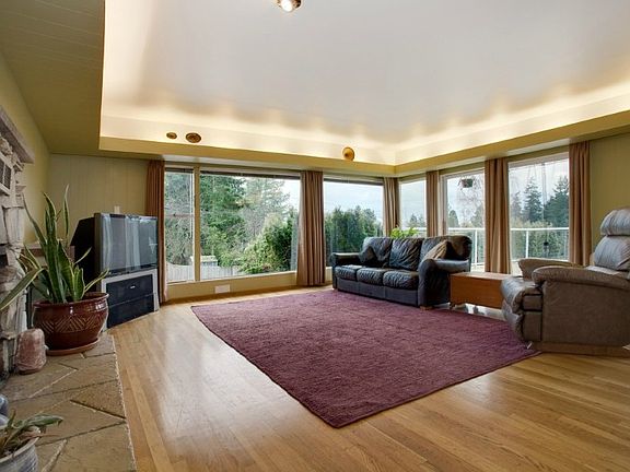 Huge living/dining area with wood burning stone fireplace and beautiful windows for views and natural light! Original wood floors throughout main level!