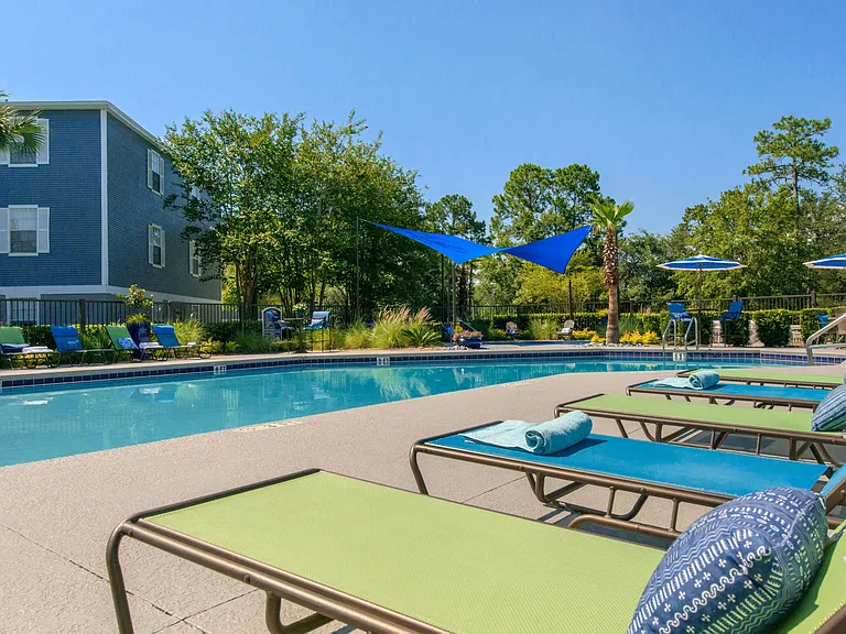 Indulge in serenity at our lakeside pool loungers. Comfort and beauty intertwine in this magical setting.