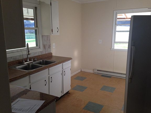Clean kitchen w new linoleum tile, new countertop and restor