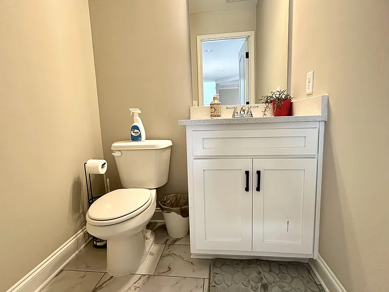 Shared half bathroom with sink and toilet