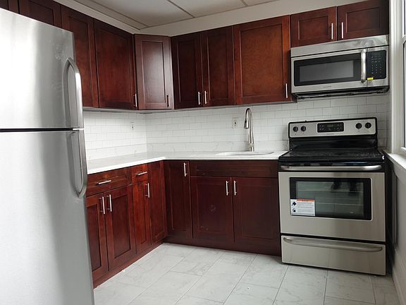 Kitchen with subway tiles, stainless steel appliances, new tiles, new closets