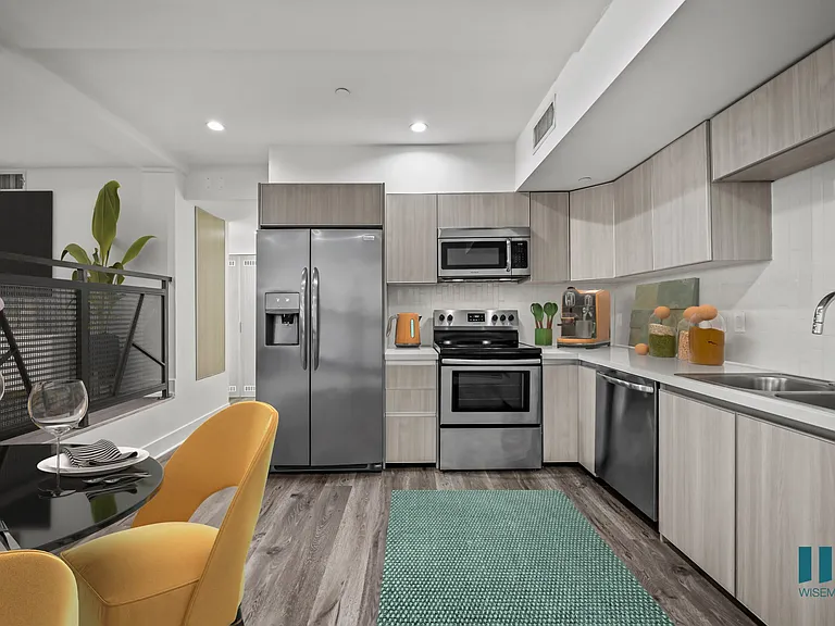 Open-Concept Kitchen with Stainless-StKitchen with Refrigerator, Stove, Microwave Oven, and Dishwasher - Two-Bedroom Two-Bathroom - Unit 108
