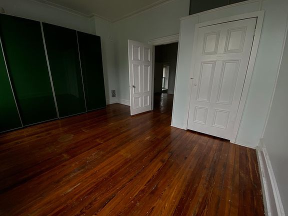 Front bedroom showing extra closet and doorway to middle room