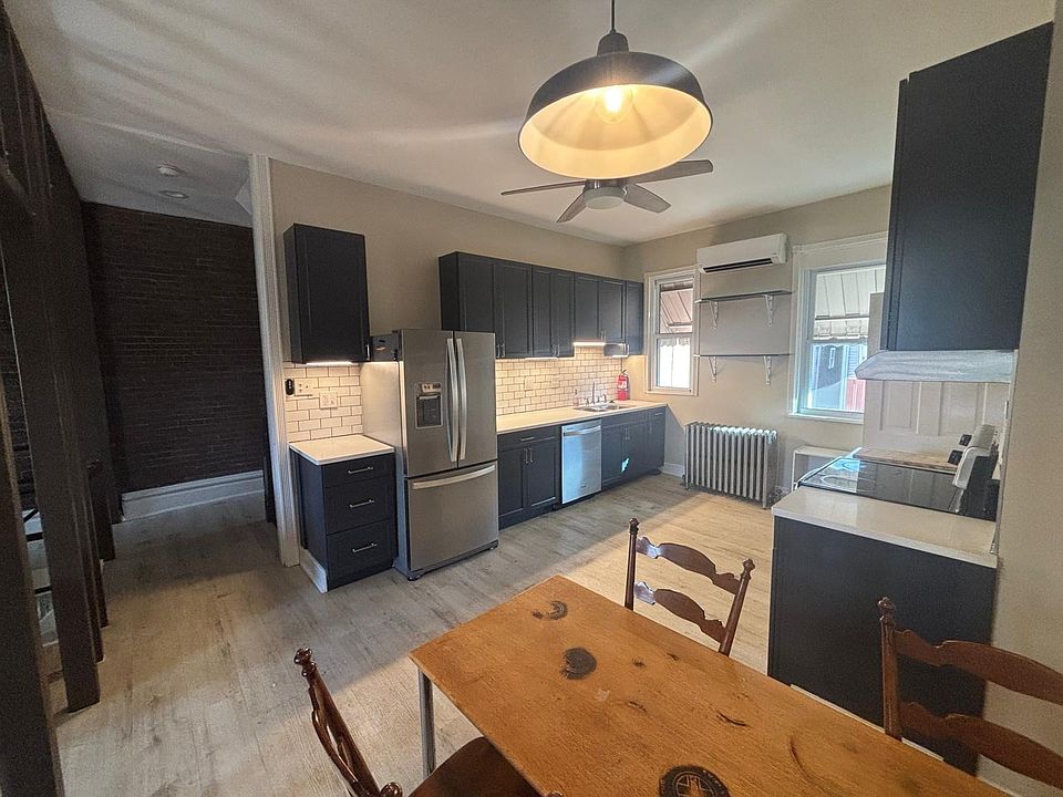 Kitchen featuring dishwasher, refridgerator, and electric stove (each less than two years old), dining area, ample prep space, backlit counterspace, and built in pantry.