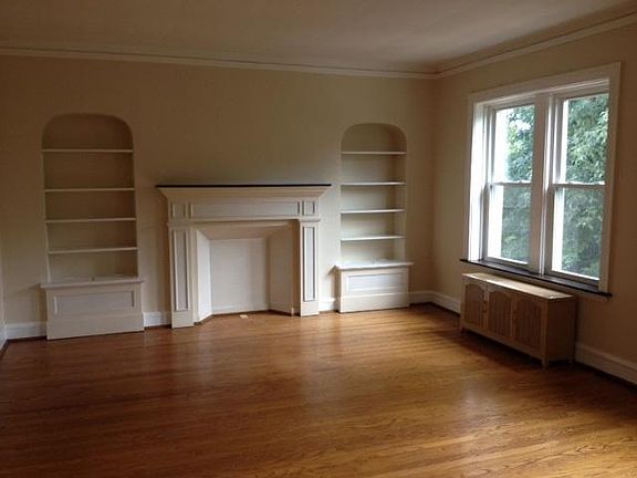 Living Room with ornamental fireplace and built in shelving