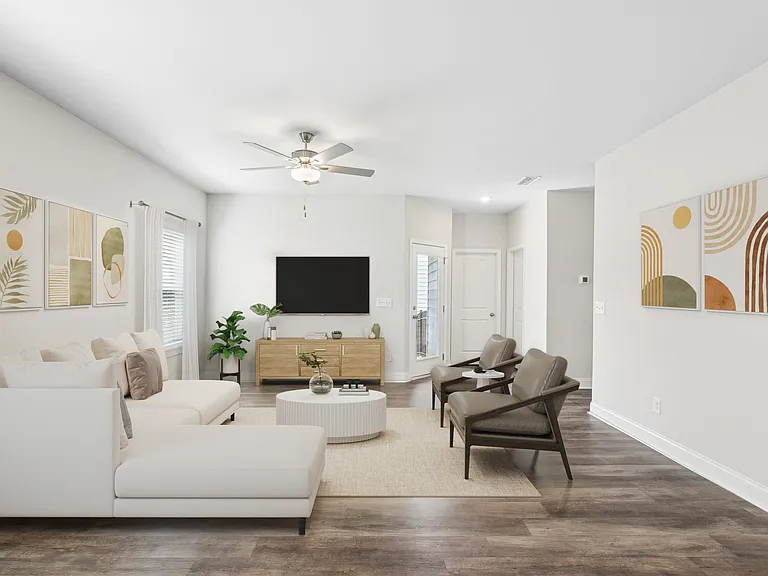 Living room with large window letting in a ton of natural light.