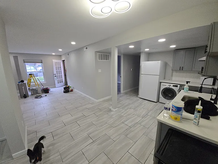 Another photo of kitchen looking into living at patio door from next to front door