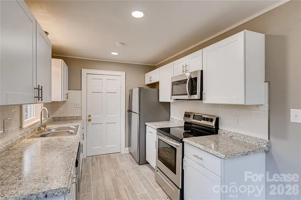Updated kitchen has white shaker cabinetry. - 340 Wilson St
