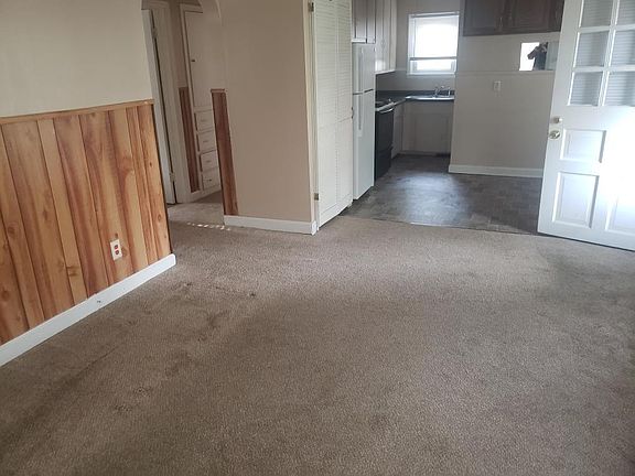 Living room looking toward interior hallway, dining room and kitchen