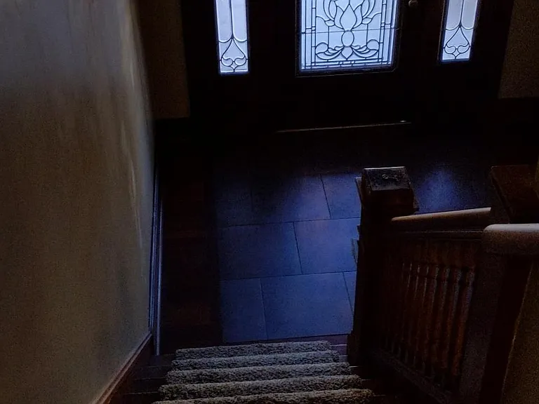 View of front door from the stairway