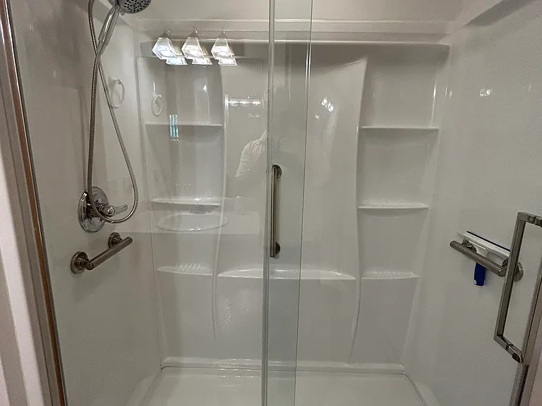 Main upstairs bathroom in hallway with walk in shower
