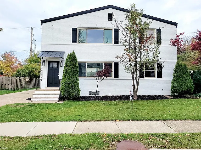 Exterior freshly painted crisp white with black accents.