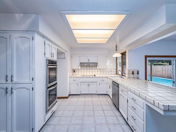 Kitchen with new stainless appliances, including a double oven.