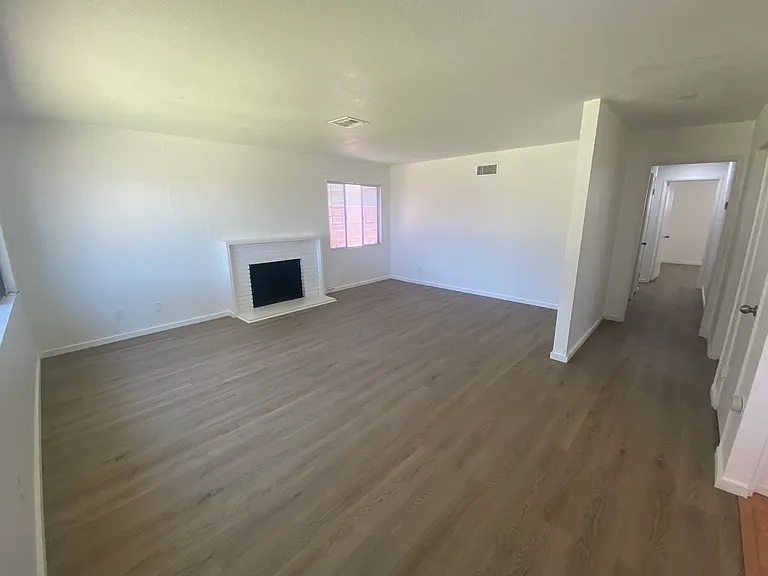 Living room with fireplace. Hardwood floors. Newly painted interior