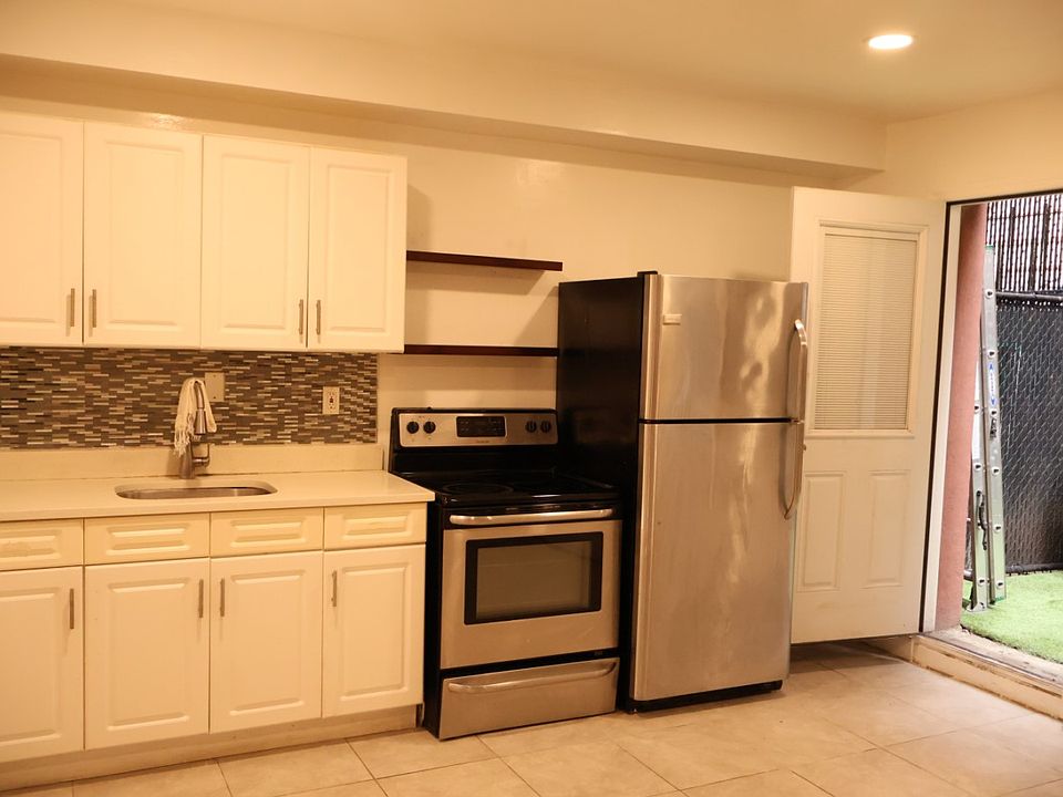 Bright white kitchen leads seamlessly to outdoor space!