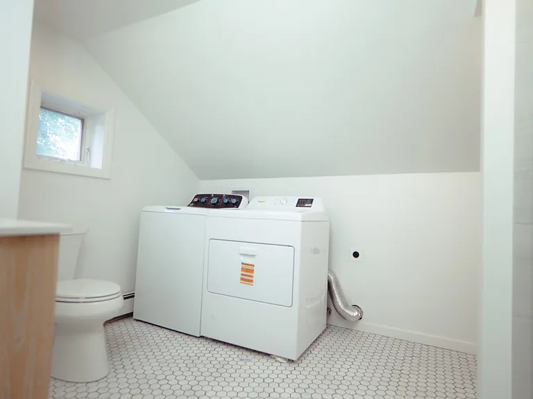 Second floor bathroom with new washer & dryer. Newly renovated.