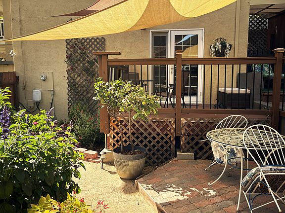 Side privately gated garden area with french doors to one of the bedrooms.