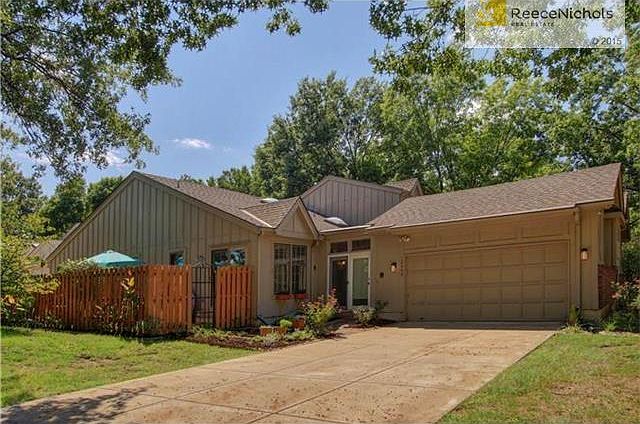 Updated townhouse on corner lot w/ long, flat driveway and two car garage.