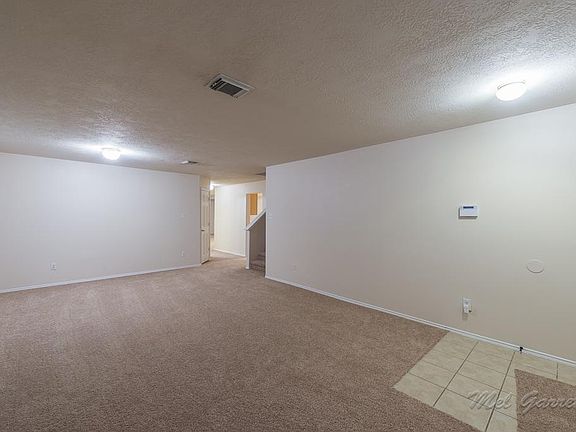 Open living room with a half bathroom attached.