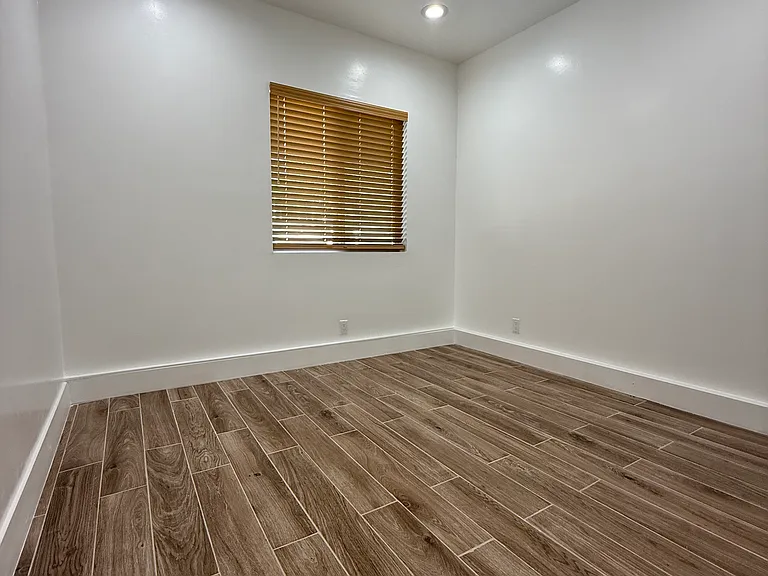 Large bedroom window allows natural light.