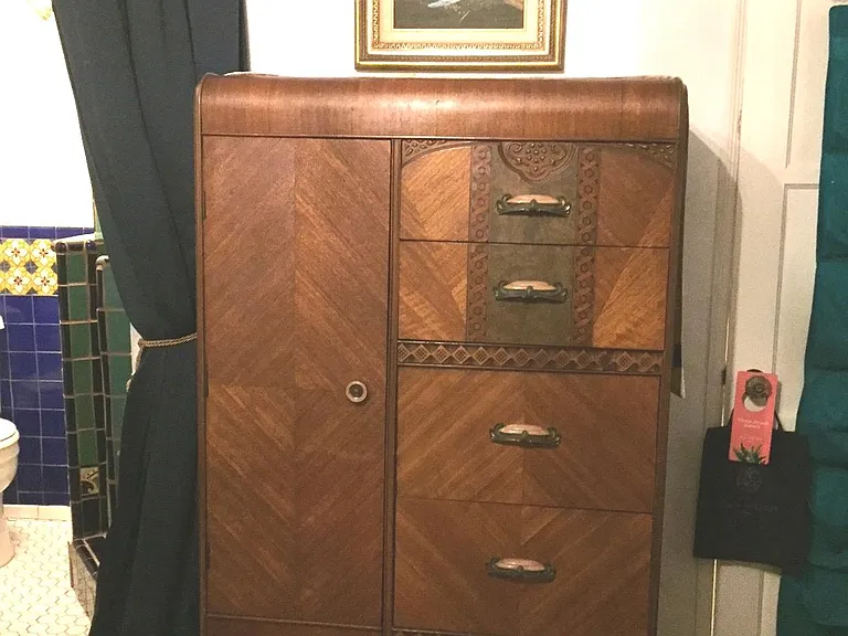 Large tall dresser with deep drawers and additional hanging or storage to the left