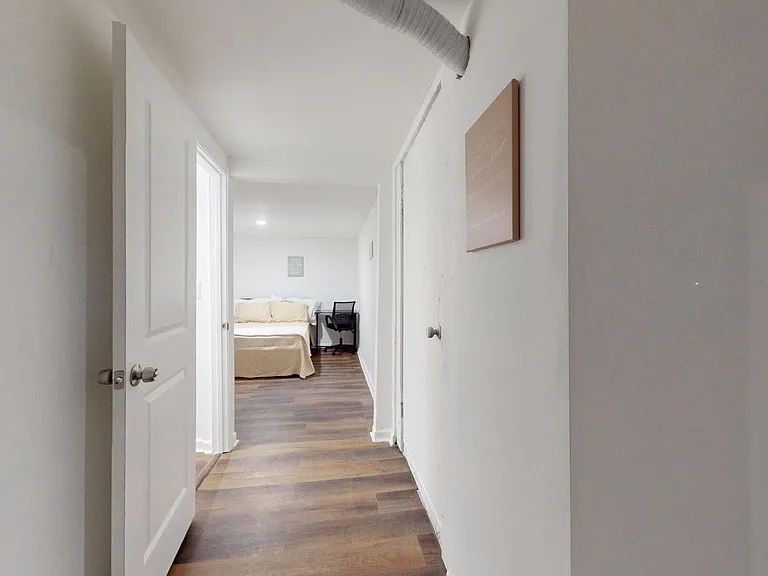 Private room entry with wood-look floors and a simple layout for rest and study.