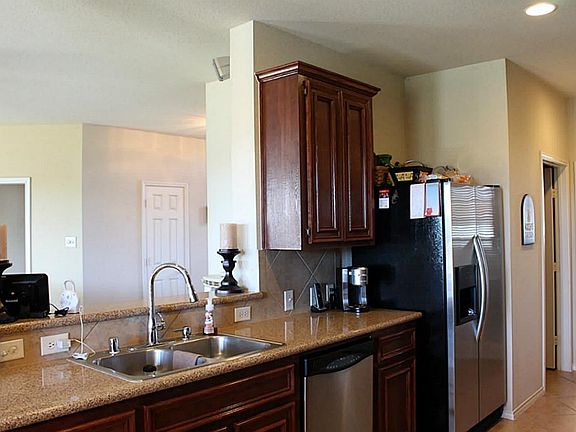 Kitchen open to family room. Note extra seating area at bar
