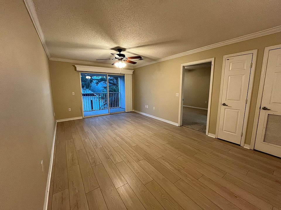 Living and Dining room. From left to right there is the Patio sliding door, the entrance to the Master Bedroom, a small Storage Closet to the left of A/C Water Heater Closet.