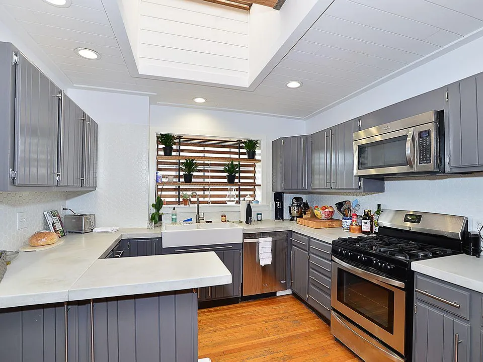 Open kitchen with stainless steal appliances including fridge/freezer, dishwasher, built in microwave, and gas stove/oven.