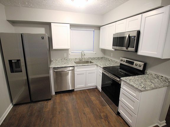 Kitchen has brand new stainless steel appliances, granite counters, and Shaker cabinets
