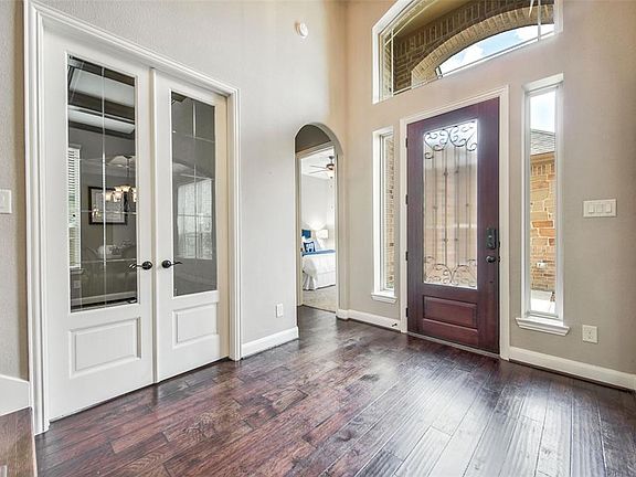 Study/library located through oversized french doors, with lovely etched glass design. 8' oversized doors throughout most of the home, and 10'+ ceilings throughout first floor of home.