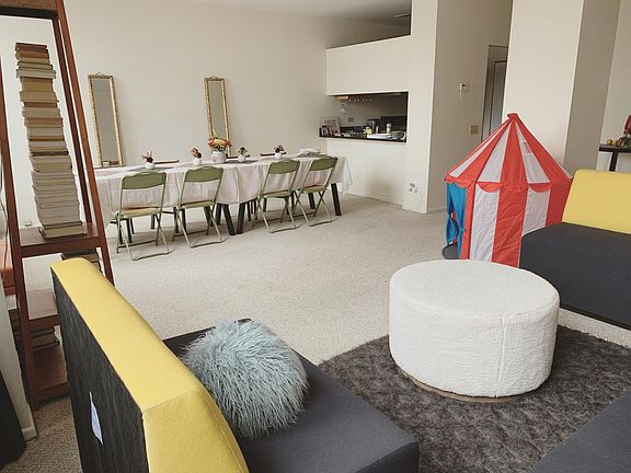 Another view of the living room, looking toward dining table and kitchen (little tent for visiting kid snuck in there, usually it's stored, and chaise is stored in this picture.