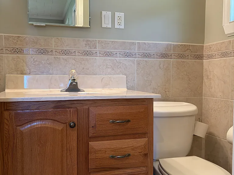 Secondary bedroom with its own private full bathroom, offering added comfort and convenience for guests or family members.