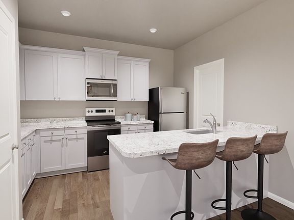 Kitchen with granite countertops and white cabinets