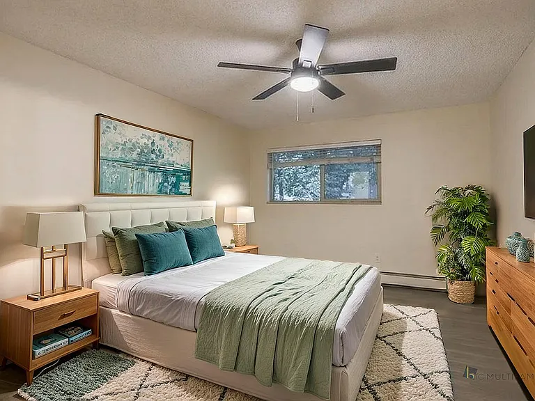 Inviting bedroom with a cozy bed, stylish decor, and soft lighting, perfect for relaxation.