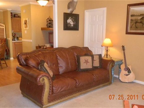 JUST INSIDE ENTRY, OPEN LIVING OVERLOOKS FRONT PORCH