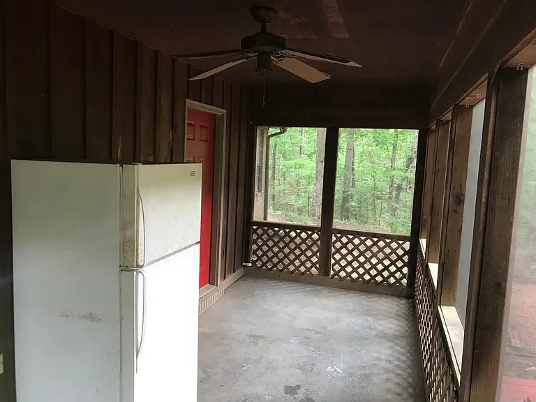 Rear screened in porch with extra refrigerator.