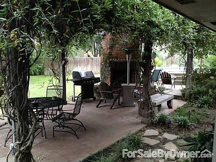 12x24 pergola built using rough sawn cypress wood. Stained concrete.