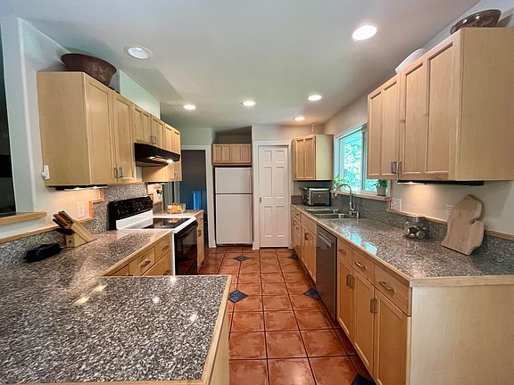 Kitchen with large pantry to the right of the fridge.