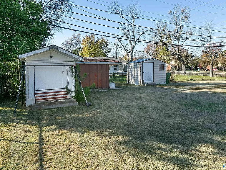 View showing the storage sheds in the back yard. ONE of the sheds will be made available for the tenant's use.