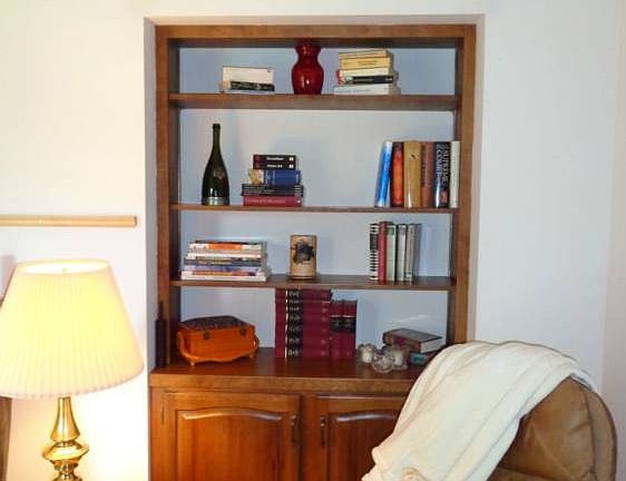 Built in cabinet at one end of living room.